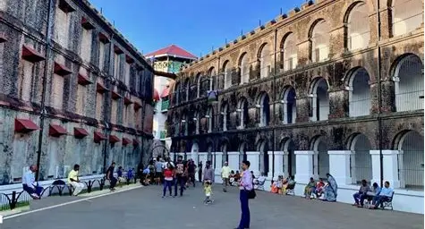 Tourists walk between the imposing stone wings of the Cellular Jail in the Andaman Islands.