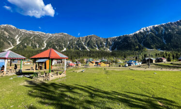 small hut with red roof in front of mountain
