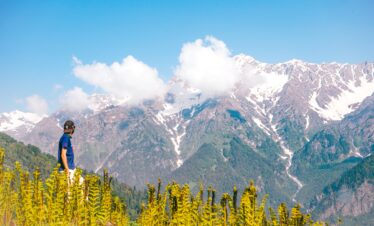 A young man enjoying the beautiful view of mountains